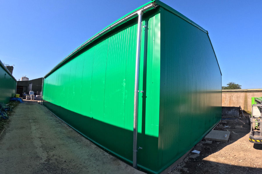 temporary warehouse building with guttering and downpipes